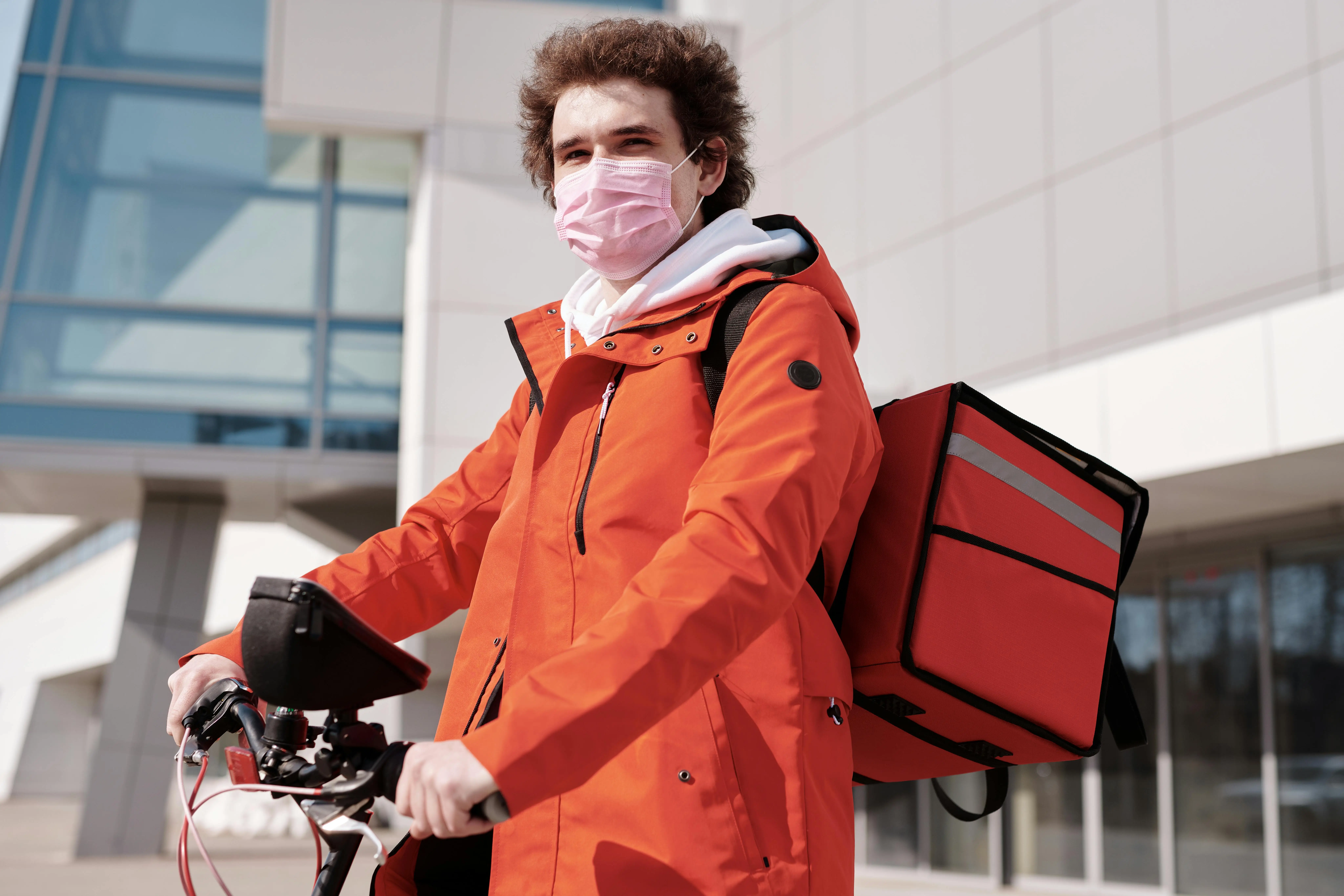 A courier carrying boxes from a delivery van