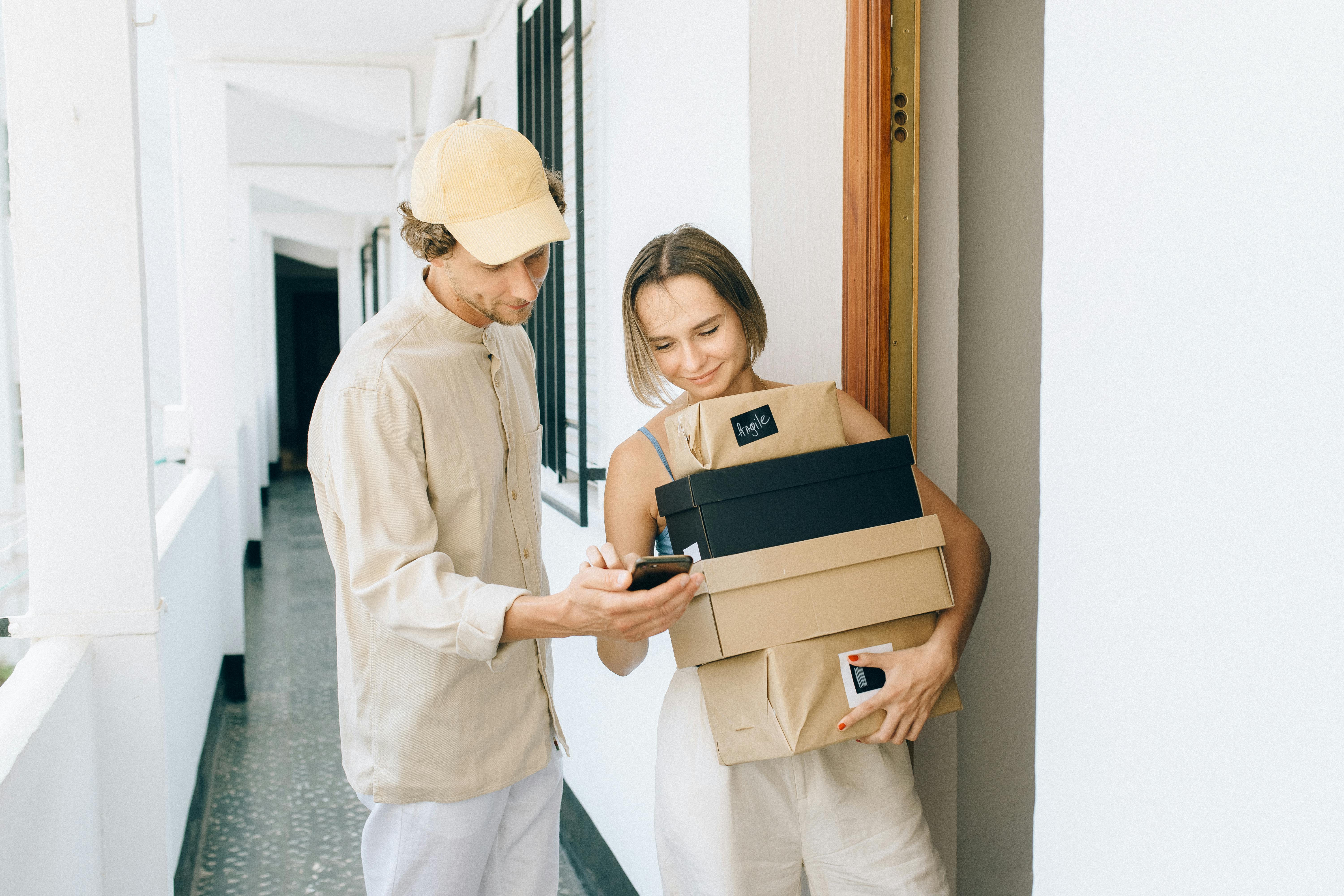 A courier checking a parcel before delivery