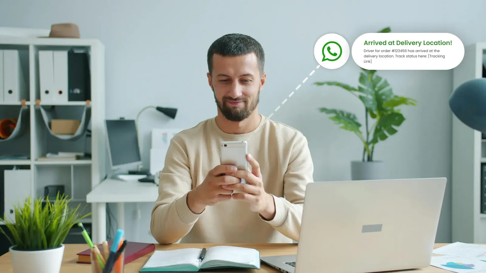 A customer receiving an 'arrived at delivery location' message on WhatsApp