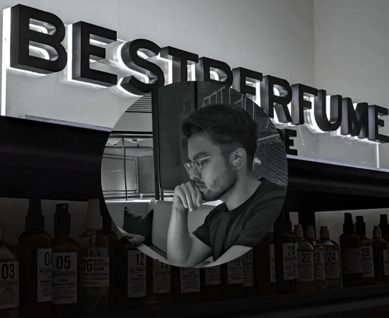 The BestPerfume.Store sign with a portrait inset of a man seated in the store